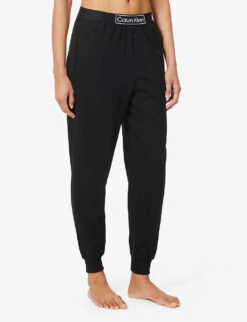 Calvin Klein Reimagined Logo-band Relaxed-fit Mid-rise Cotton-recycled Polyester Blend Jogging Bottoms 9 Calvin Klein Reimagined Logo-band Relaxed-fit Mid-rise Cotton-recycled Polyester Blend Jogging Bottoms -Sweaty Betty Store R03875729 BLACK ALT02