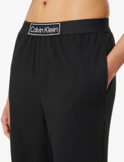 Calvin Klein Reimagined Logo-band Relaxed-fit Mid-rise Cotton-recycled Polyester Blend Jogging Bottoms 11 Calvin Klein Reimagined Logo-band Relaxed-fit Mid-rise Cotton-recycled Polyester Blend Jogging Bottoms -Sweaty Betty Store R03875729 BLACK ALT04