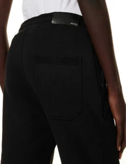 Amiri Floral Logo-print Tapered Cotton Jogging Bottoms 11 Amiri Floral Logo-print Tapered Cotton Jogging Bottoms -Sweaty Betty Store R04191415 BLACK ALT04